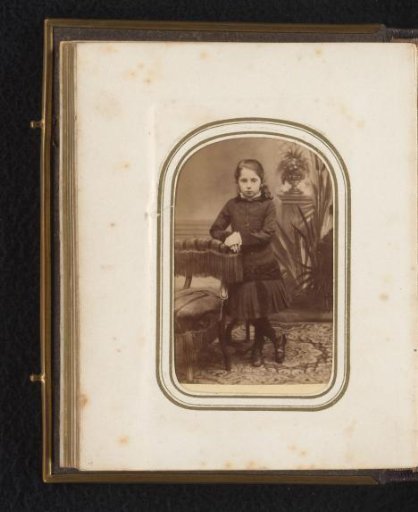 Portrait of a girl by a chair