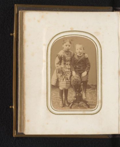 Portrait of a Girl and a Boy Sitting on a Stool