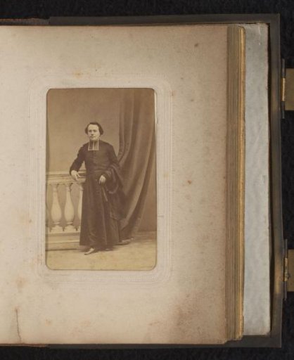 Portrait of a man, standing by a balustrade