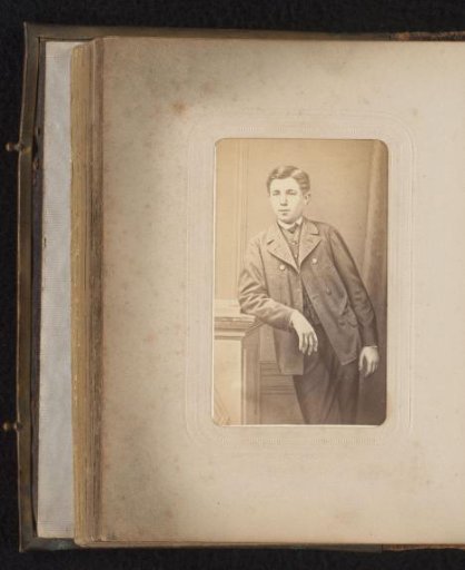 Portrait of a boy leaning on a pedestal