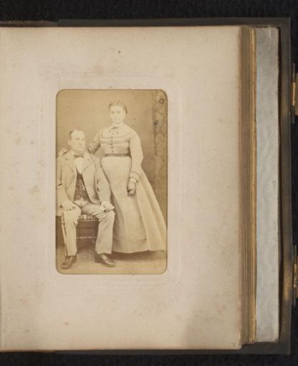 Portrait of a seated man and a standing woman