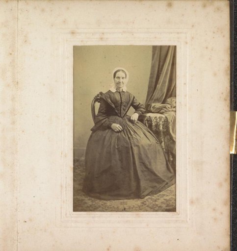 Portrait of a woman with a cap, seated