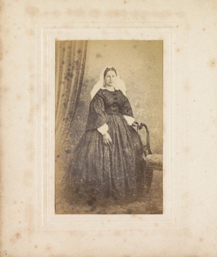 Portrait of a woman with a veil cap, standing
