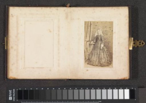 Portrait of a woman with a veil cap, standing