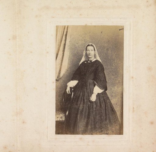 Portrait of a woman with a veil cap, standing