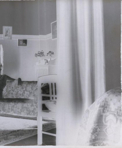 Woman designated as Suzi seated on a bench in a room