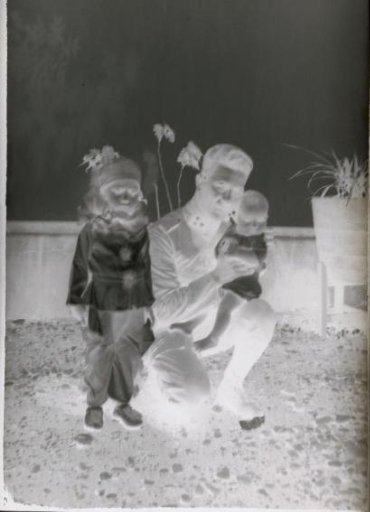 Man with two children, one dressed as a Pierrot