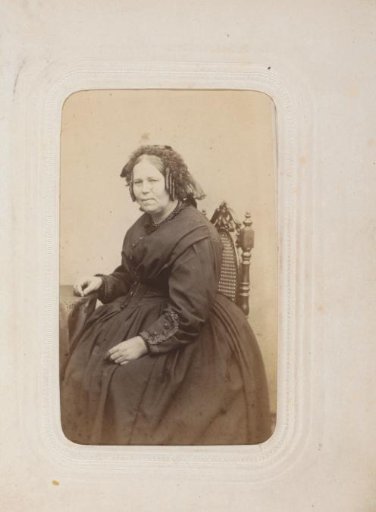 Portrait of a seated woman with ringlets and a cap