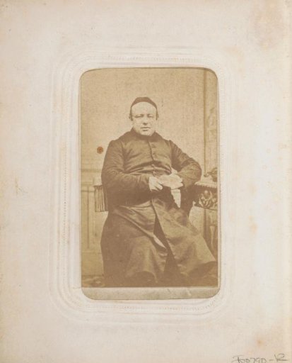 Portrait of a seated cleric wearing a skullcap and holding a book
