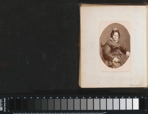 Portrait of a seated woman with ringlets and a cap