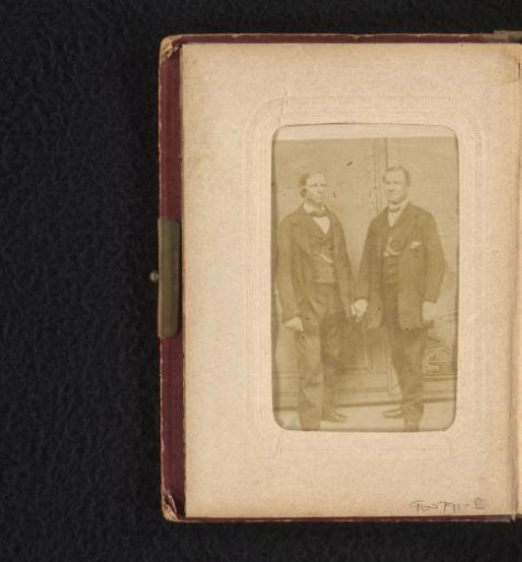 Portrait of two standing men, hand in hand