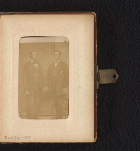 Portrait of two standing men, hand in hand