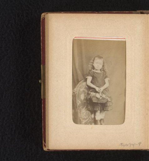Portrait of a girl, standing on a chair, with a flower basket
