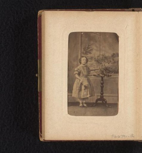 Portrait of a girl, standing with a book in her hand
