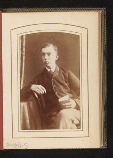Portrait of a seated man with a book in his hand