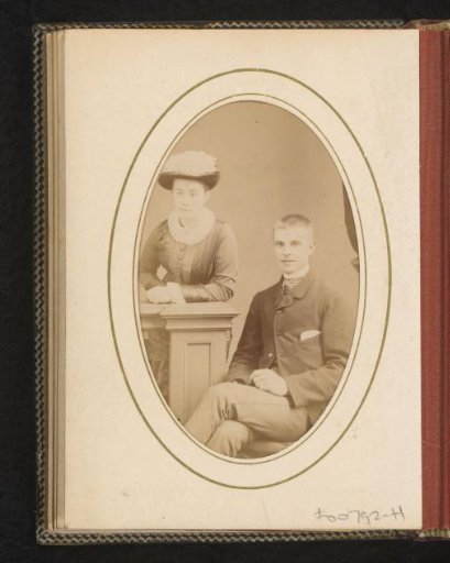Portrait of a seated young man and a standing young woman