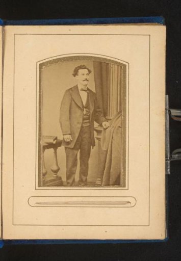 Portrait of a standing man with a moustache