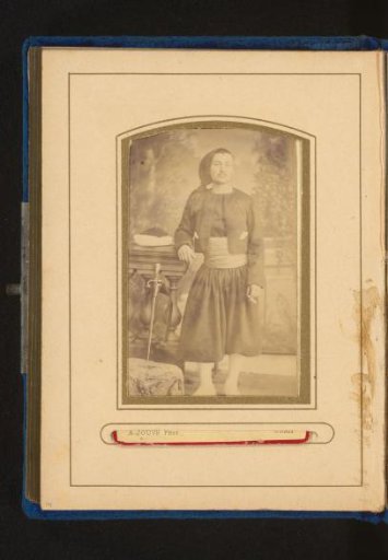 Portrait of a standing man with a cap