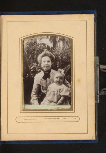 Portrait of a young woman with a child on her lap
