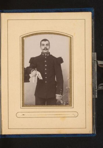 Portrait of a man in military uniform holding gloves