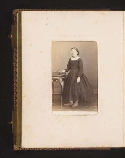 Portrait of a Girl Standing by a Table