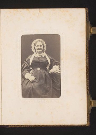 Portrait of a Woman with a Cap, Seated at a Table with Books