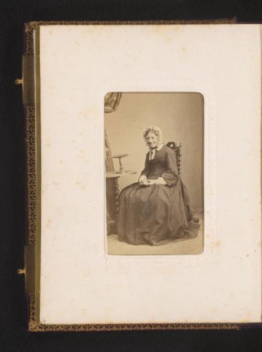 Portrait of a Seated Woman with a Cap and Book in Hand