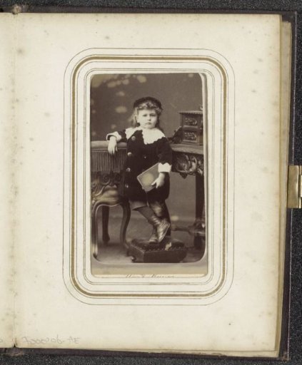 Portrait of a standing child with a book in hand