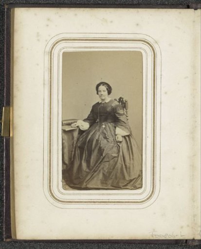 Portrait of a seated woman with a cap