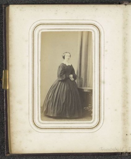 Portrait of a standing woman by a table