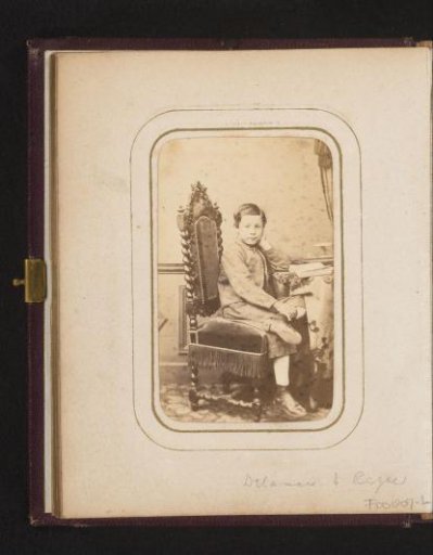 Portrait of a boy, sitting on a settee