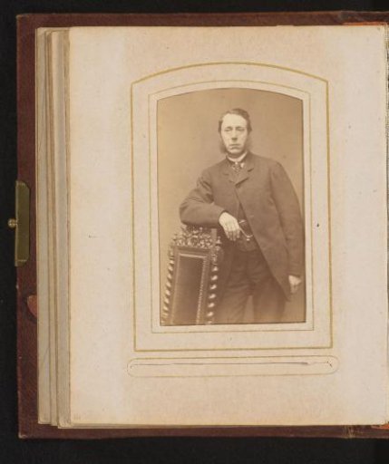Portrait of a man leaning on a chair