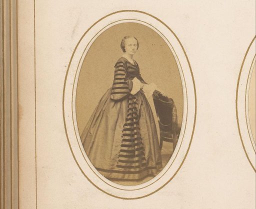 Portrait of a woman standing by a chair