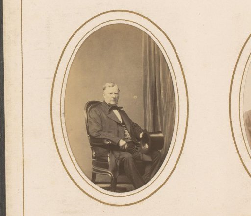 Portrait of a seated man with a tall hat in his hand