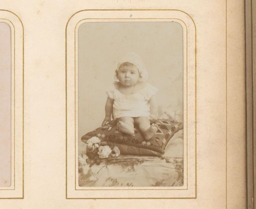 Portrait of a Seated Baby with a White Cap