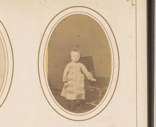 Portrait of a girl standing by a chair