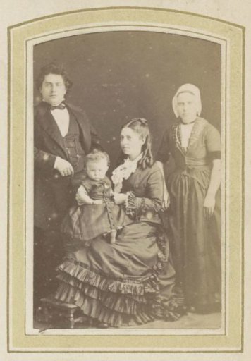 Portrait of a man, a baby and two women, one in a dress, the other with a cap