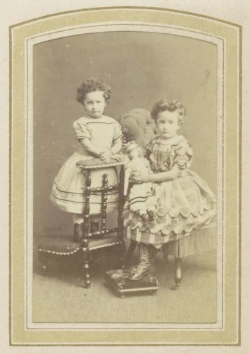 Portrait of Two Girls in Dresses with a Doll