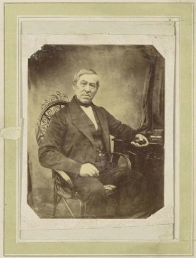 Portrait of a Seated Man Holding an Object