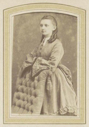Portrait of a Young Woman in a Dress Leaning on a Chair