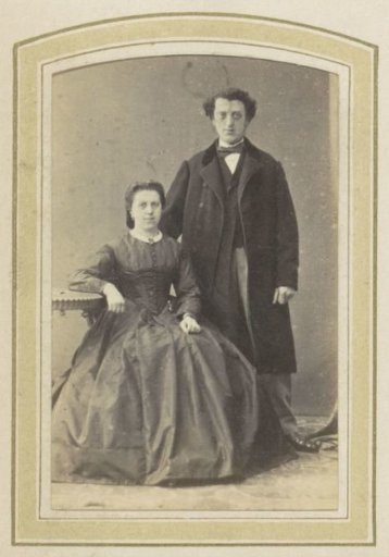 Portrait of a man in a long coat and a woman in a dress