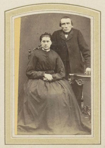 Portrait of a man in a long coat and a woman in a dress