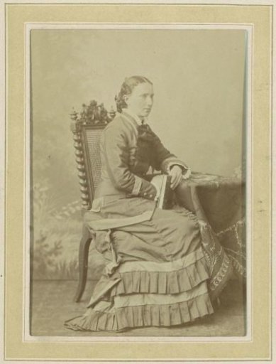 Portrait of a Seated Woman in a Dress at a Table