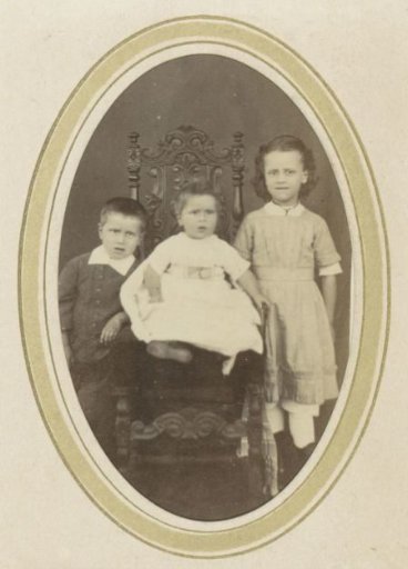 Portrait of Three Children Including a Girl in a Dress and a Toddler