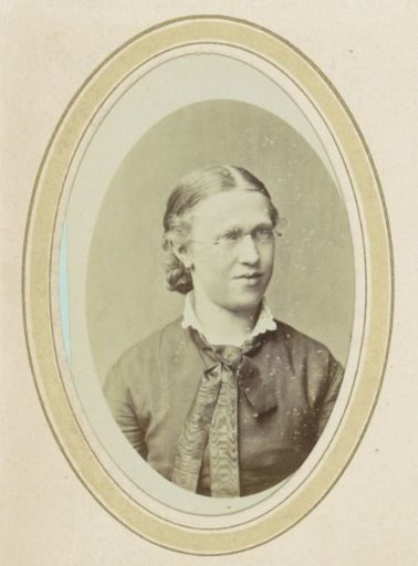 Portrait of a young woman with spectacles and a bow