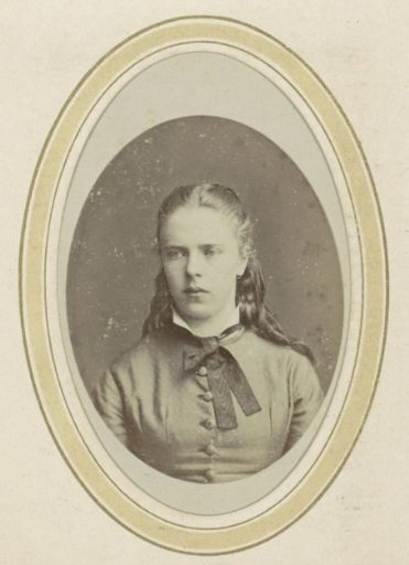 Portrait of a young woman with tied hair and a bow