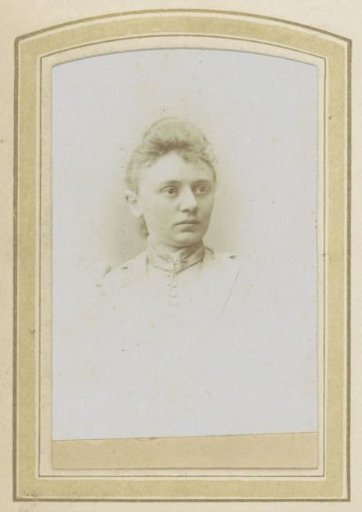 Portrait of a woman in a high-collared blouse with a brooch and a topknot