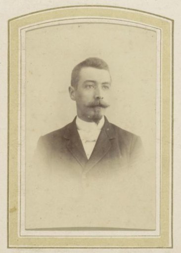 Portrait of a man with a mustache, a sideburn, a coat and a cravat