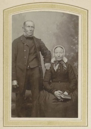 Portrait of a man in a coat and a woman with a cap and a dress