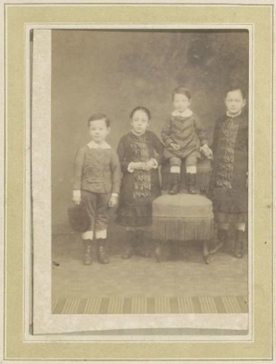 Portrait of Four Children by a Chair